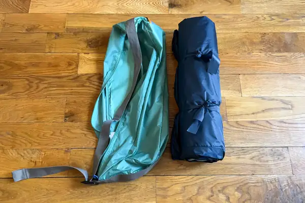 The Kelty Cabana Shelter rolled up next to a storage bag