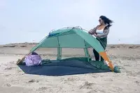 A person assembles the Kelty Cabana Shelter