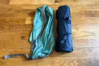 The Kelty Cabana Shelter rolled up next to a storage bag