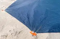 The base of the Kelty Cabana Shelter secured in sand
