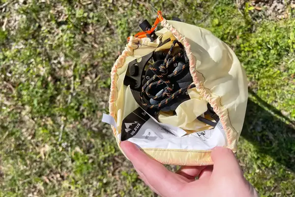 Person opening the carrying case for the Oileus XL Beach Tent 