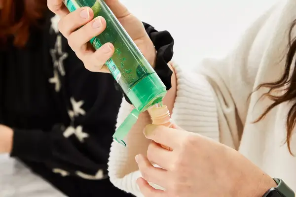Person filling the INSFIT TSA Carry-on Approved Containers with product