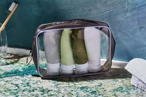 The INSFIT TSA Carry-on Approved Containers in a zip pounch on a counter