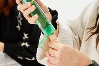 Person filling the INSFIT TSA Carry-on Approved Containers with product