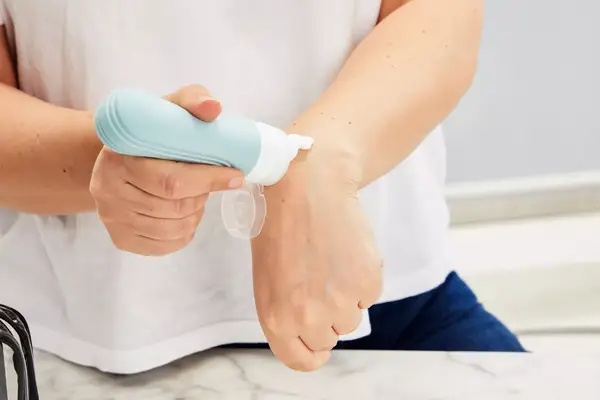 Person applying product from a Mrsdry Travel Bottle