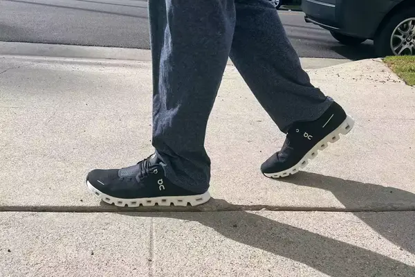 Side view of a man wearing a prAna Fleece Hoodie and a backpack
