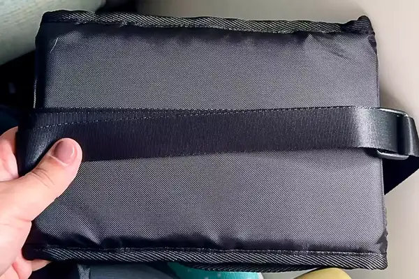 A person holding the Beskar Airplane Foot Rest