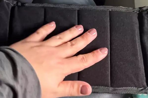 A hand on the Beskar Airplane Foot Rest