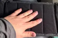 A hand on the Beskar Airplane Foot Rest