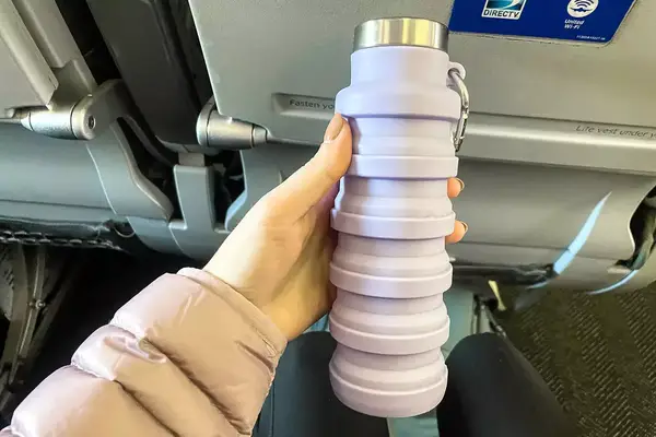 A person holding the Vadoworld Collapsible Water Bottle