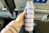 A person holding the Vadoworld Collapsible Water Bottle