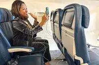 A person holding a phone that is plugged in with the Tumaber 3-Pack Apple 10-foot Lightning to USB Cords