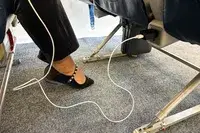 Tumaber 3-Pack Apple 10-foot Lightning to USB Cords plugged into an airplane seat