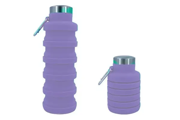 A person wearing the Ostrich Pillow Go Neck Pillow on a plane 