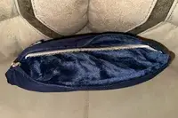 Travelrest 4-in-1 Travel Blanket carrying pouch displayed unzipped on a gray surface