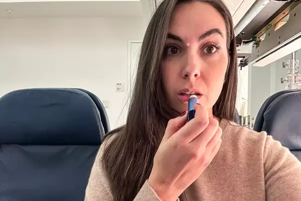 A person applying the Wild Lip Balm