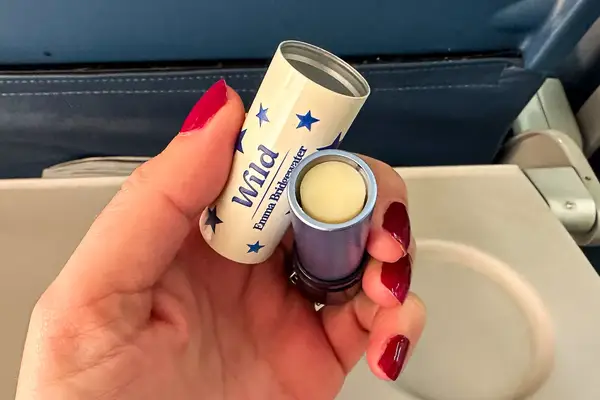 A hand holding the Wild Lip Balm
