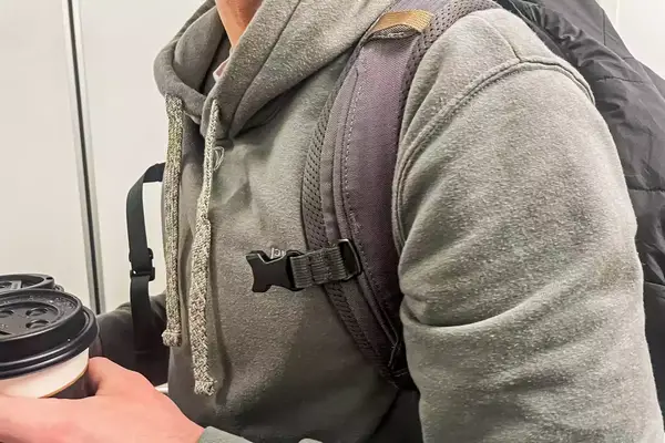 Side view of a man wearing a prAna Fleece Hoodie and a backpack