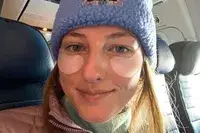 A person sitting in an airplane wearing the Knesko Diamond Radiance Collagen Eye Mask