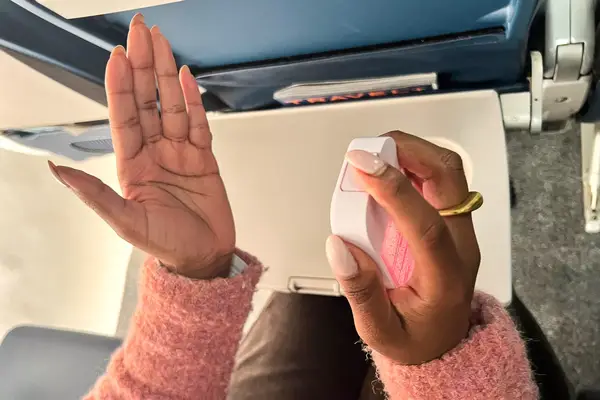 A person applying the Touchland Power Mist Hand Sanitizer