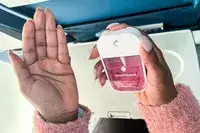 A person applying the Touchland Power Mist Hand Sanitizer