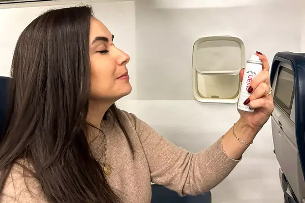 A person applying the Evian Facial Spray