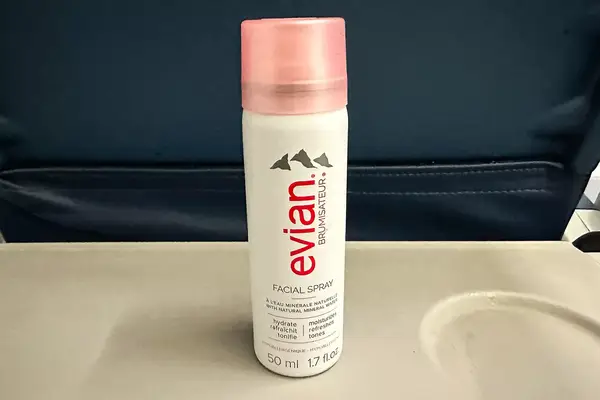 Evian Facial Spray on an airplane seat tray