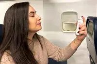 A person applying the Evian Facial Spray