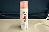Evian Facial Spray on an airplane seat tray