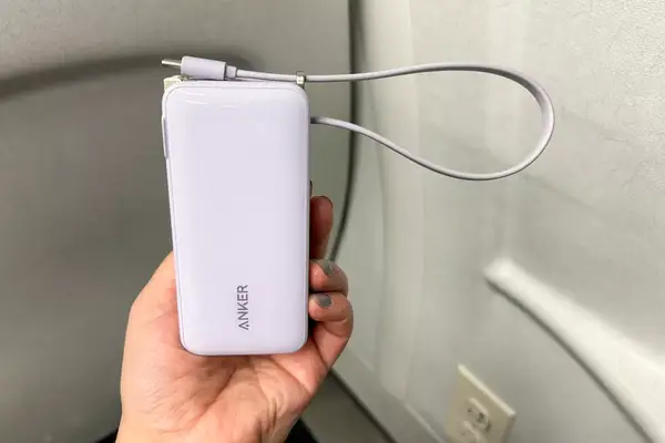 A hand holding the Anker Nano 3-in-1 Portable Power Bank