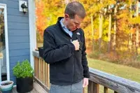 Man zipping up The North Face Denali Zip Jacket