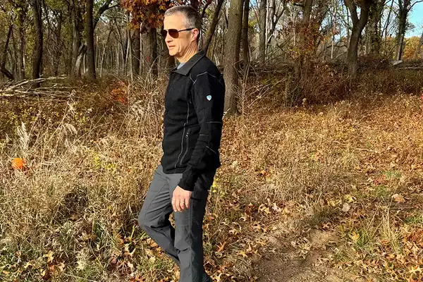 A person wearing the KUHL Interceptr Full-Zip Jacket outdoors