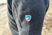 A close up of the logo on the sleeve of the KUHL Interceptr Full-Zip Jacket