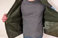 A person wearing the Cotopaxi Teca Fleece Full-Zip Jacket and showing off the inside