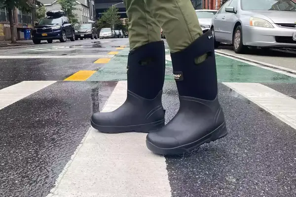 A person wears Bogs Men’s Bozeman Tall Yulex Boots outside