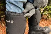 A person cinches the cord on a pair of Kamik Men