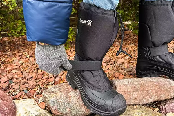 A person tightens a strap on the Kamik Men