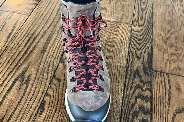 A person laces up the Danner Arctic 600 Side-Zip Boots
