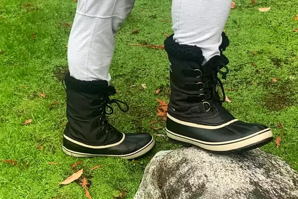 A person wears the Sorel Menâs 1964 Pac Nylon Boots outside