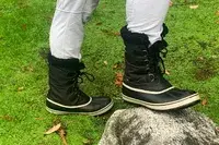 A person wears the Sorel Menâs 1964 Pac Nylon Boots outside