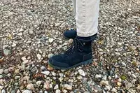 A person wears the Bogs Arcata Urban Leather Mid Men
