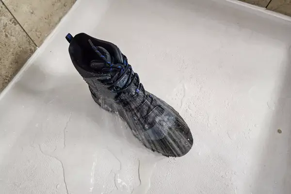 The Columbia Men’s Bugaboot III Boot in a shower with water on it
