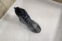 The Columbia Men’s Bugaboot III Boot in a shower with water on it