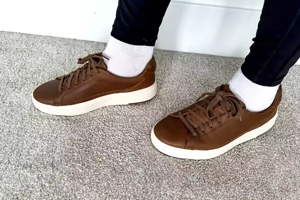 A person posed on carpet while wearing the Kizik Women’s Vegas Sneakers