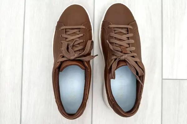 An overhead view of the Kizik Women’s Vegas Sneakers on a light wood floor