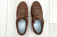 An overhead view of the Kizik Women’s Vegas Sneakers on a light wood floor