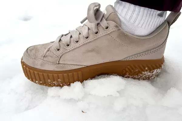 A close-up of a Sorel Ona Ave Low Waterproof Sneaker on snow