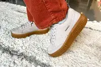 A close-up of two feet posing while wearing the Sorel Ona Ave Low Waterproof Sneakers