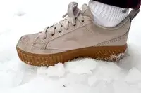 A close-up of a Sorel Ona Ave Low Waterproof Sneaker on snow