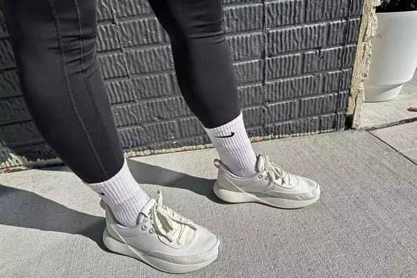A person walks outside while wearing the Allbirds Women